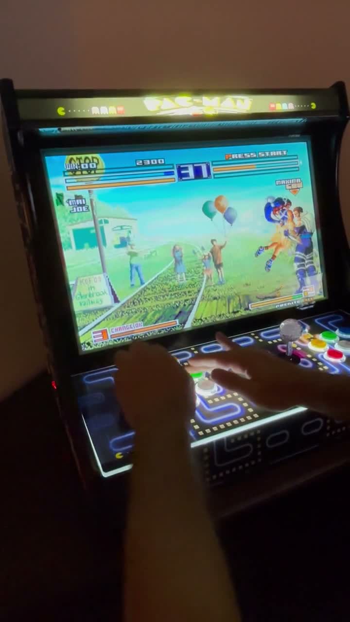 Two players competing in The King of Fighters on a CherryQuest arcade machine