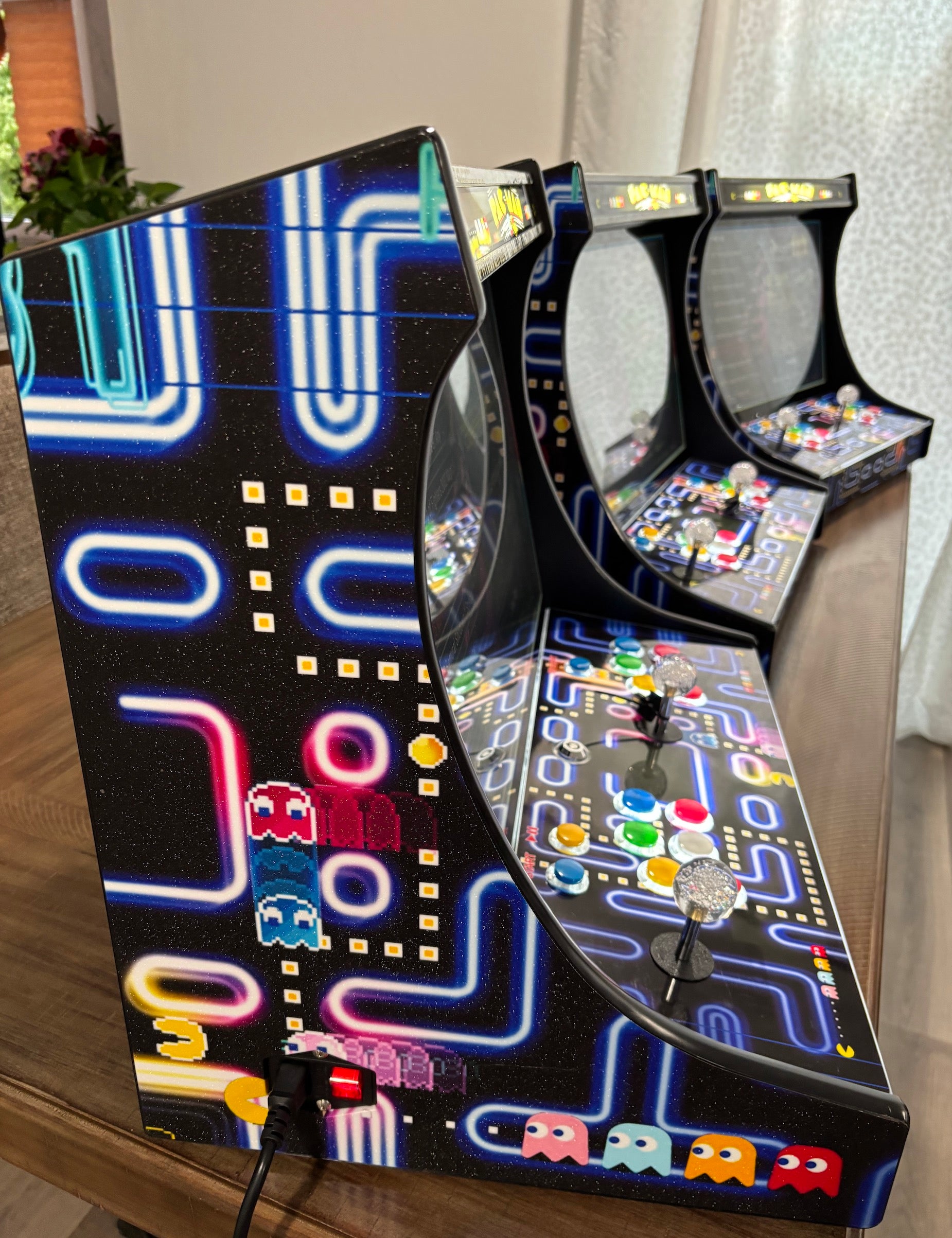 Three CherryQuest 22-inch tabletop arcade machines showing illuminated side artwork